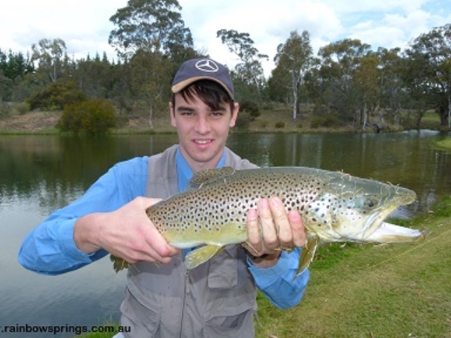 A young man realeasing a monster trout