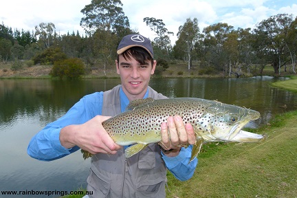 A young man realeasing a monster trout