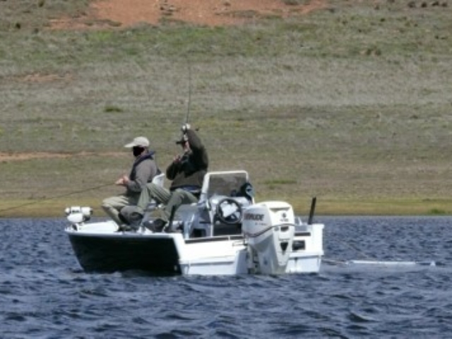 Boat and anglers on lake Tantangara