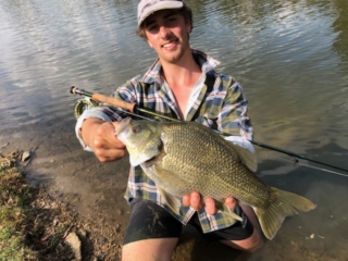 A picture of releasing a big Bass with great care