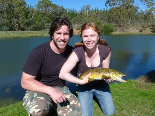 A happy couple holding a fish at Rainbow Sprngs Fly Fishing School