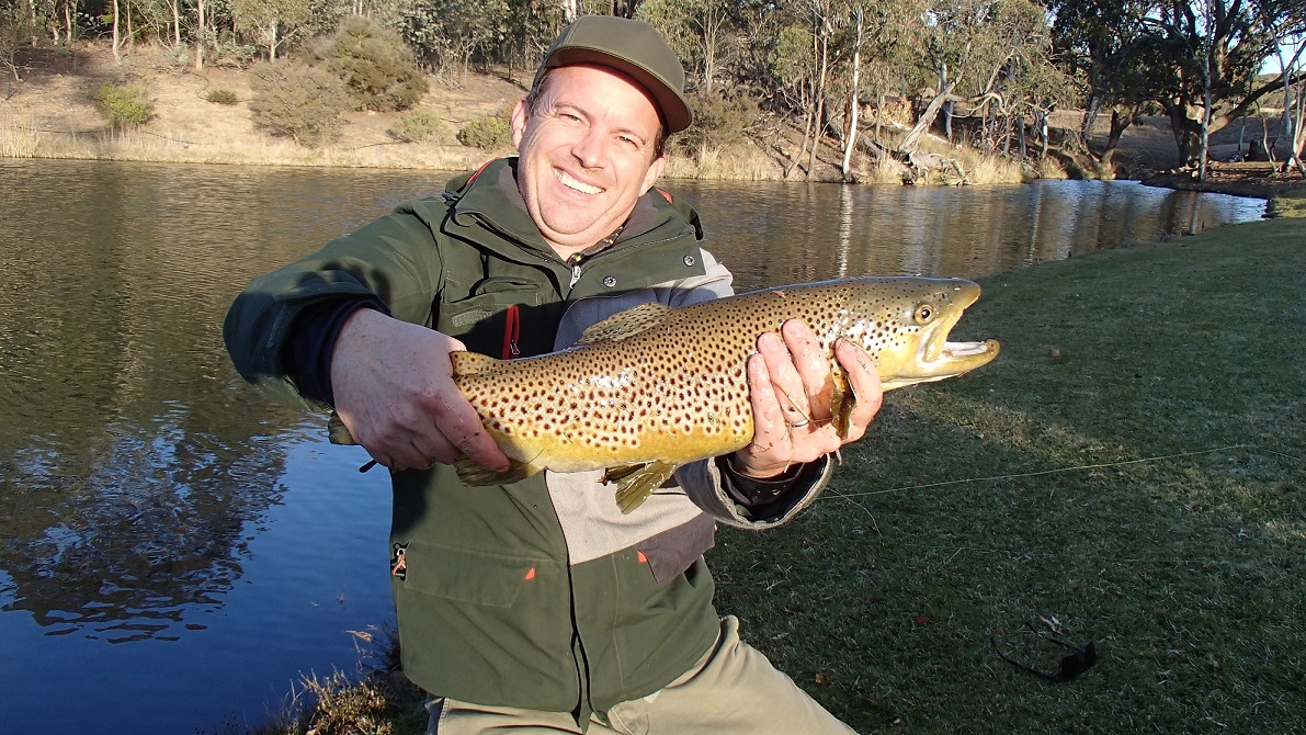 Smiles all round with this big brown trout