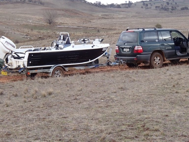 Picture of 4wd and boat on muddy road