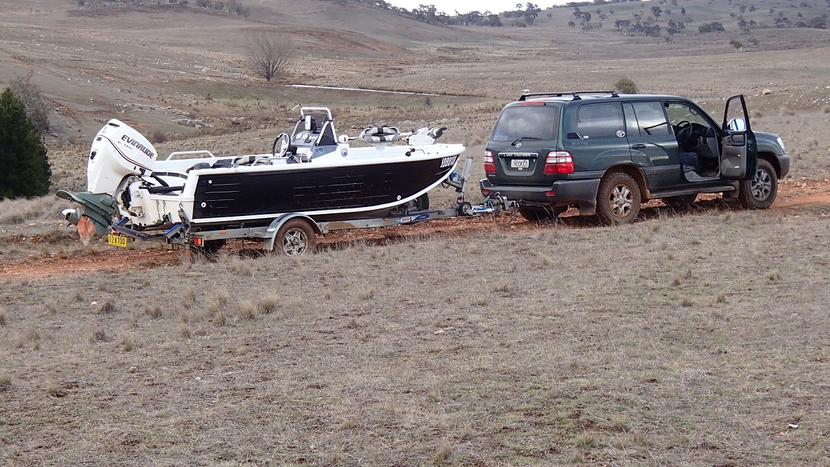 Picture of 4wd and boat on muddy road