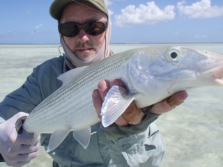 A man catching a Bonefish on the flats