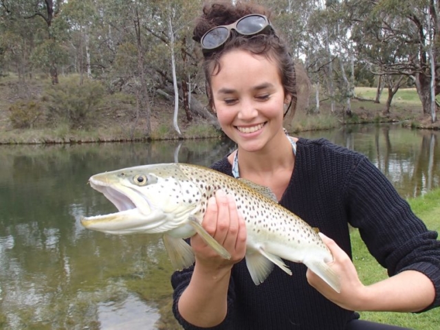 A young lady very happy with her catch