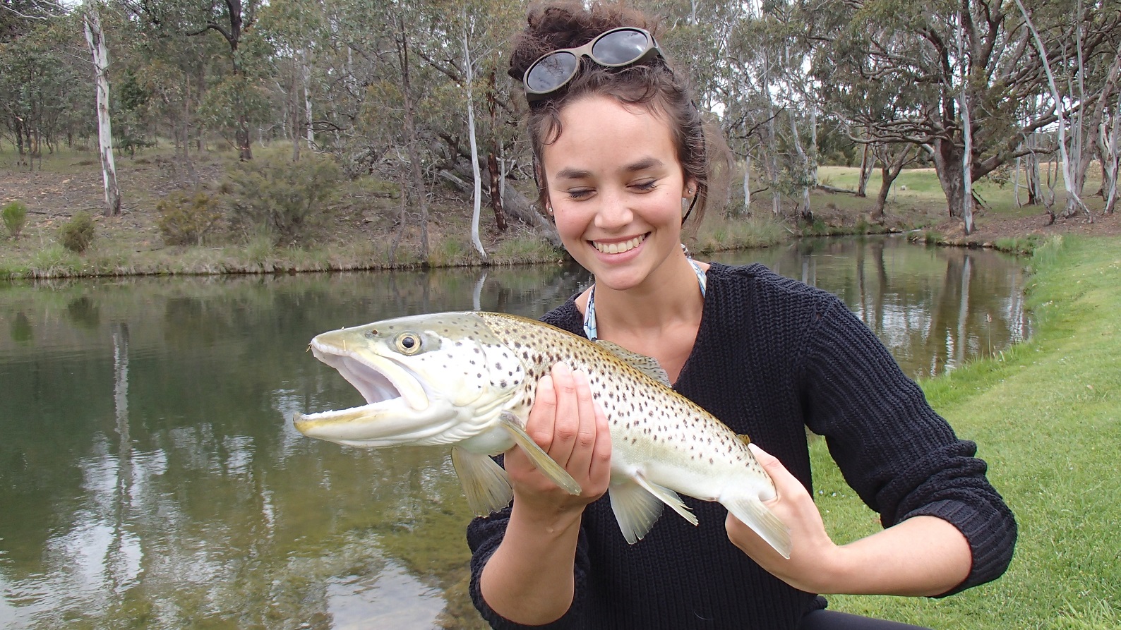 A young lady very happy with her catch