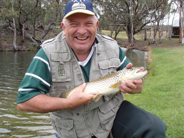 A fly fisher with a big big smile