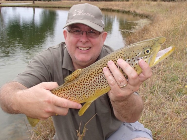 A man wearing the correct color clothing so as not to scare fish