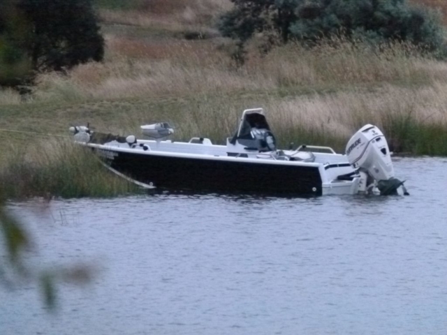 A boat tied up by the lakes edge