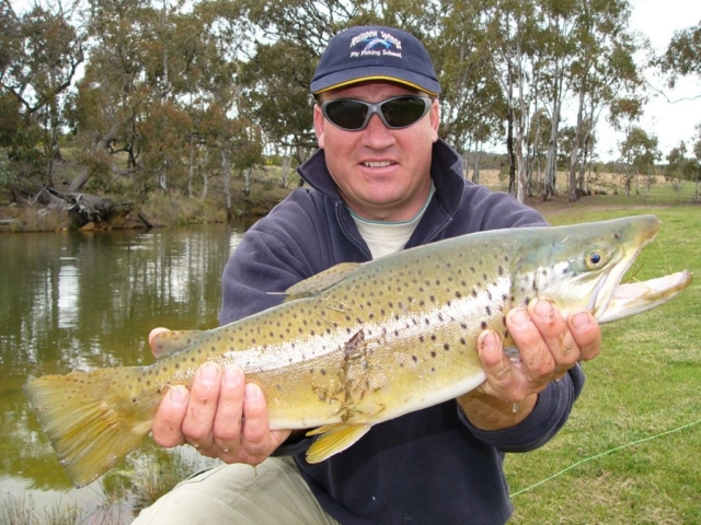 A happy chat ready to release a big brown trout