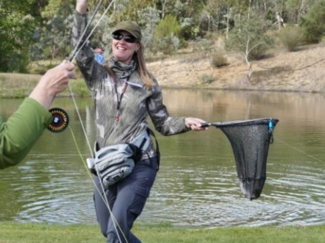 A couple of ladies gining a high five for their catch